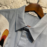 JW ANDERSON LIGHT BLUE SHIRT WITH EMBROIDERED SWANS