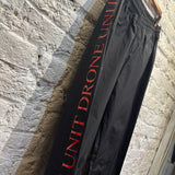 MCQ	BLACK ""UNIT DRONE"" PIPING TRACK BOTTOMS