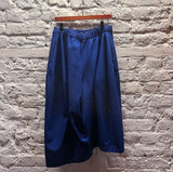 COMME DES GARÇONS
BLUE POLY OVERSIZE DROP SHORTS