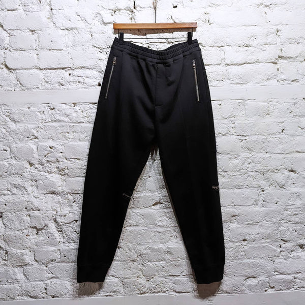 ALEXANDER MCQUEEN 
BLACK ZIP JOGGERS WITH CAMO DETAILS