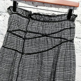 COMME DES GARÇONS
TRICOT BLACK WHITE HOUND TOOTH CHECKERED SKIRT WITH ELASTIC DETAILS AD 2003