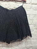 CARVEN 
BLACK PLEATED SQUARE CUT OUT MINI SKIRT